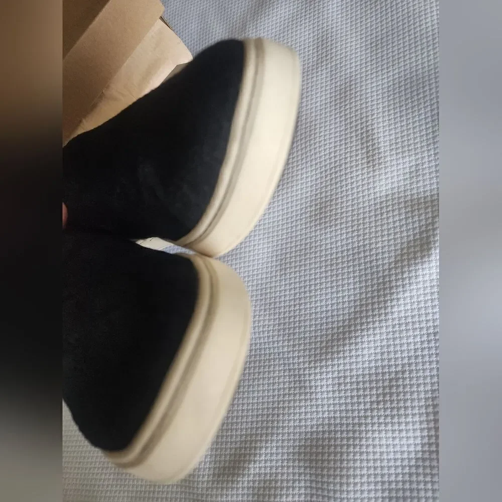 OluKai Black and White Flats Sleek Slip-On Design
